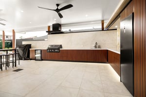 Custom outdoor kitchen with Spotted Gum AliBattens cabinetry and 60mm Corian Whisper benchtops