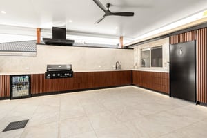 Custom outdoor kitchen with Spotted Gum AliBattens cabinetry and 60mm Corian Whisper benchtops