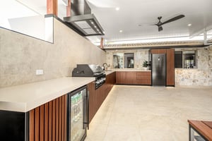Custom outdoor kitchen with Spotted Gum AliBattens cabinetry and 60mm Corian Whisper benchtops