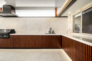 Custom outdoor kitchen with Spotted Gum AliBattens cabinetry and 60mm Corian Whisper benchtops