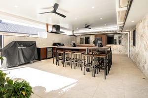 Custom outdoor kitchen with Spotted Gum AliBattens cabinetry and 60mm Corian Whisper benchtops