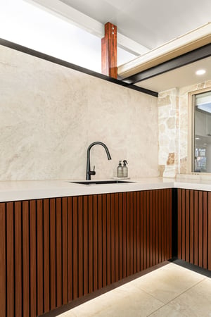 Custom outdoor kitchen with Spotted Gum AliBattens cabinetry and 60mm Corian Whisper benchtops