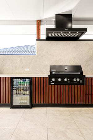 Custom outdoor kitchen with Spotted Gum AliBattens cabinetry and 60mm Corian Whisper benchtops