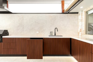 Custom outdoor kitchen with Spotted Gum AliBattens cabinetry and 60mm Corian Whisper benchtops