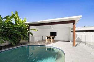 Two-part outdoor kitchen with built-in BBQ and outdoor fridges