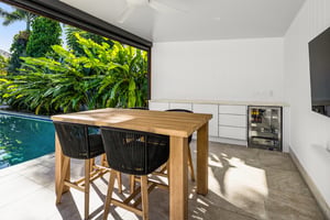 Two-part outdoor kitchen with built-in BBQ and outdoor fridges