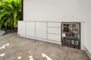 Two-part outdoor kitchen with built-in BBQ and outdoor fridges