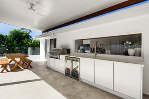 Two-part outdoor kitchen with built-in BBQ and outdoor fridges