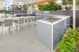 Outdoor kitchen with Heritage Grey cabinetry and Heatlie BBQs